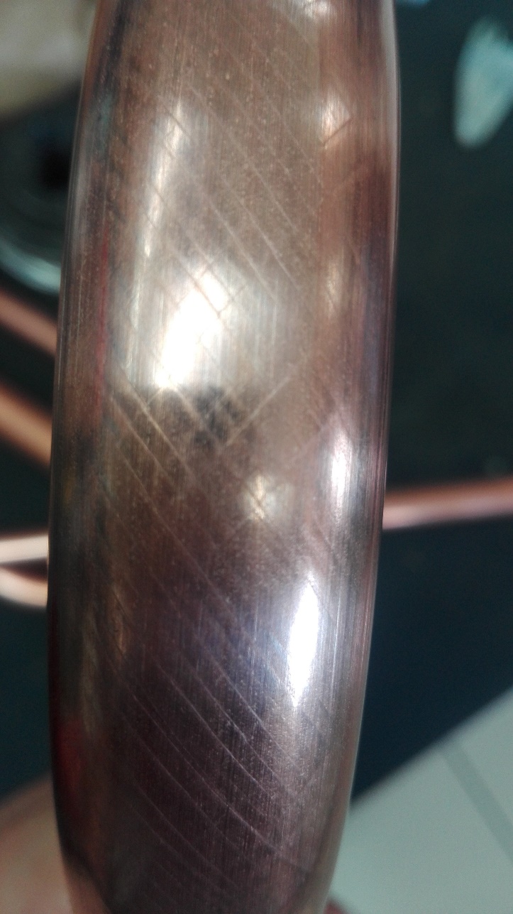 Visible Luder lines on the surface of a bent copper tube