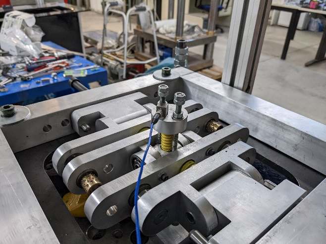 Side view of the NOESIS KDamper prototype mounted on the laboratory test bench