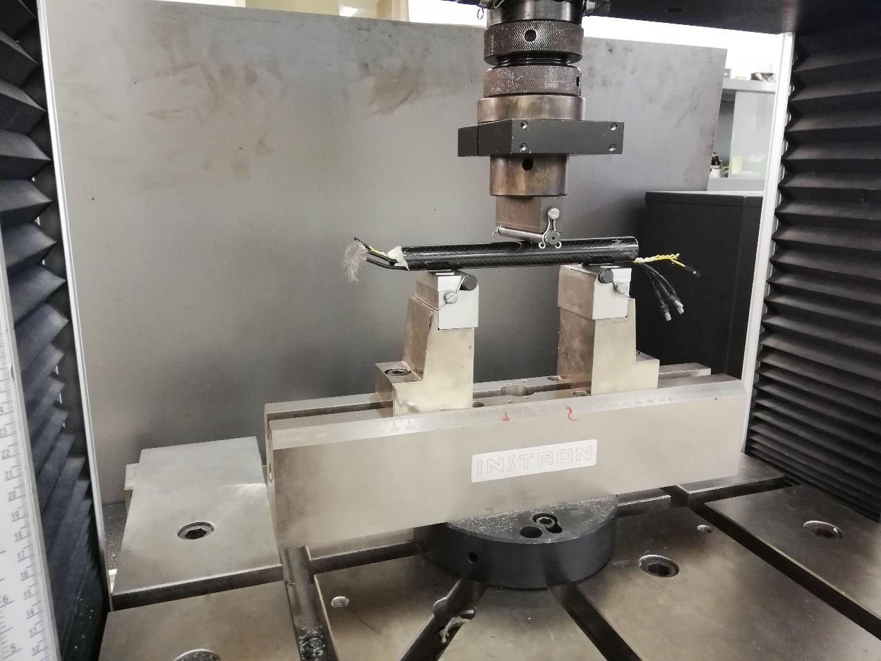 Composite UAV specimen positioned on an INSTRON machine for three-point bending
